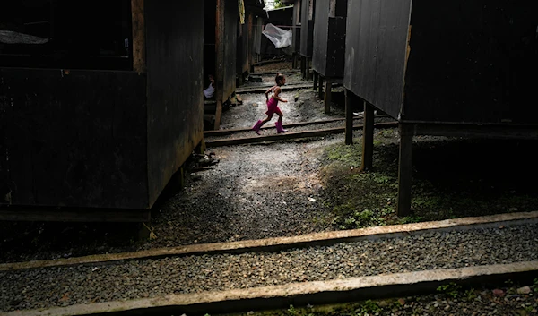 A Venezuelan migrant child runs through a temporary camp after walking across the Darien Gap from Colombia, in Lajas Blancas, Panama, on June 28, 2024. (AP)