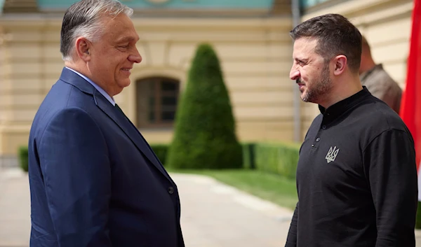 In this photo provided by the Ukrainian Presidential Press Office, Ukrainian President Volodymyr Zelensky, right, welcomes Hungarian Prime Minister Viktor Orban in Kiev, Ukraine, July 2, 2024 (Ukrainian Presidential Press Office via AP)