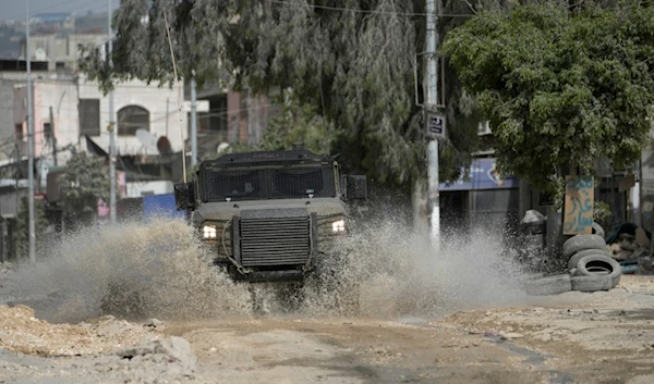 An Israeli military vehicle raids the Nur Shams refugee camp, near the West Bank town of Tulkarm, Saturday, April 20, 2024. (AP)