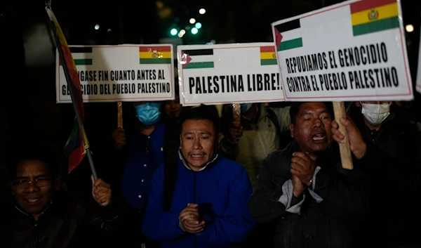 Pro-Palestinian demonstrators hold banners in Spanish lambasting "the genocide of the Palestinian people" and calling for a "Free Palestine" during a protest against Israeli attacks on Gaza, in front of the US Embassy, Bolivia, July 4, 2024. (AP)