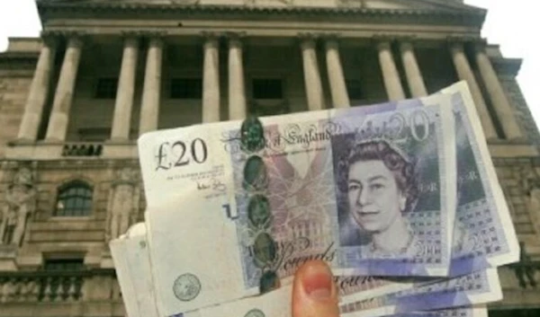 A person holding the British pound (AFP)