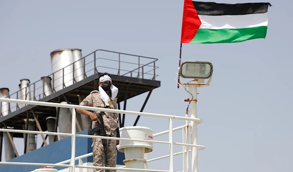 A Yemeni soldier stands on board the Israeli Galaxy ship which was seized by Ansar Allah in the port of Salif, near Hodeidah, Yemen, May 12, 2024 (AP)