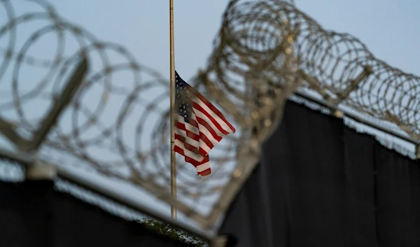 In this Aug. 29, 2021, an American flag flies as seen from Camp Justice in Guantanamo Bay Naval Base, Cuba. (AP)