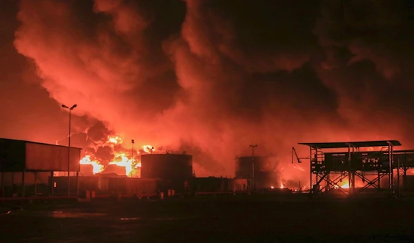 Oil tanks burn at the port in Hodeidah, Yemen, Saturday, July 20, 2024. (AP)