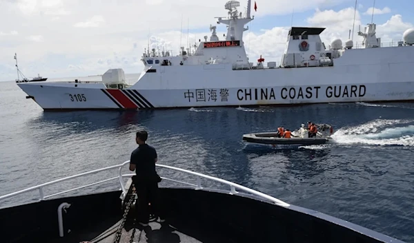 Chinese coastguard ship blocks a Philippine Bureau of Fisheries and Aquatic Resources ship as it neared the Chinese-controlled Scarborough Shoal in the disputed South China Sea in October 2023. (AFP)