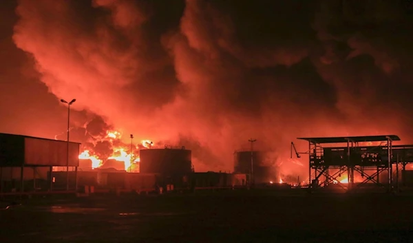 Oil tanks burn at the port in Hodeidah, Yemen, following an aggression by the Israeli occupation, July 20, 2024. (AP)