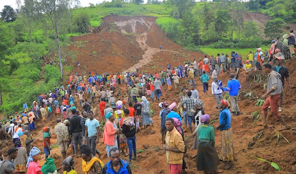 In this handout photo released by Gofa Zone Government Communication Affairs Department, hundreds of people gather at the site of a mudslide in the Kencho Shacha Gozdi district, Gofa Zone, southern Ethiopia, on July 22, 2024. (AP)