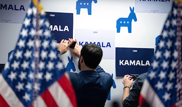 Campaign staff put up signs at Vice President Kamala Harris' campaign headquarters in Wilmington, Del., Monday, July 22, 2024. (Pool/AP)