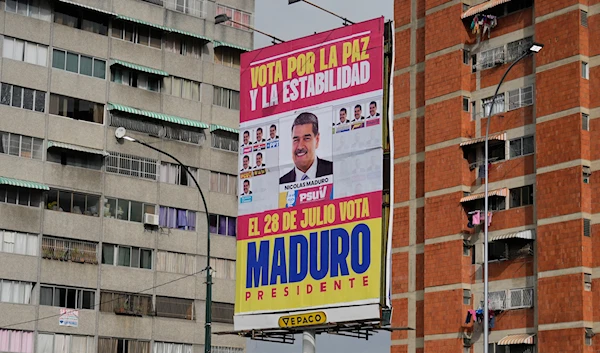 An election campaign sign for Venezuelan President Nicolas Maduro reads in Spanish "Vote for peace and stability" by residential buildings in Caracas, Venezuela, Tuesday, July 23, 2024. (AP)