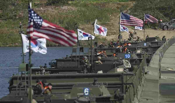 The flags of South Korea and the United States wave before a joint river-crossing drill between the two countries in Yeoju, South Korea, October 19, 2022. (AP)