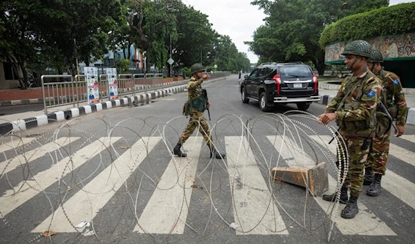 Bangladeshi military forces soldiers put up barbed wires on a main street in Dhaka, Bangladesh, Monday, July 22, 2024. (AP)