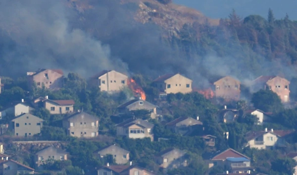 Fires and smoke rise at houses in the northern border settlement of Metula, hit by Hezbollah shelling, as seen from the Lebanese town of Marjayoun, Lebanon, Saturday, June 22, 2024. (AP)