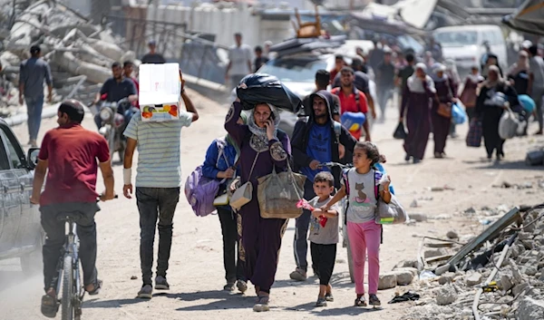 Palestinians displaced by the Israeli air and ground offensive on the Gaza Strip flee from parts of Khan Younis, Monday, July 22, 2024. (AP)