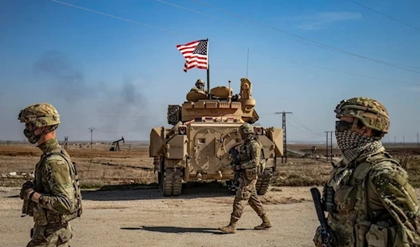 US soldiers walk by the Suwaydiyah oil fields in Syria's northeastern al-Hasakah province on February 13, 2021. (AFP)