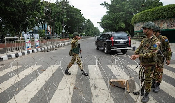 Bangladeshi military forces soldiers put up barbed wires on a main street in Dhaka, Bangladesh, Monday July 22,2024.(AP)