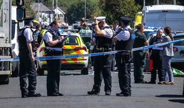 Police secure the scene of the stabbing in Southport, on England's north-west coast. (AP)