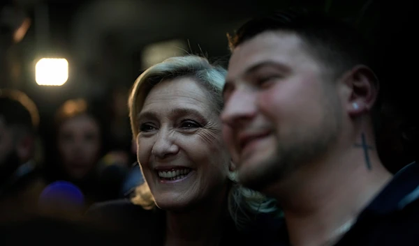 French far right leader Marine Le Pen poses for a selfie on Sunday, June 30, 2024 in Henin-Beaumont, northern France. (AP)