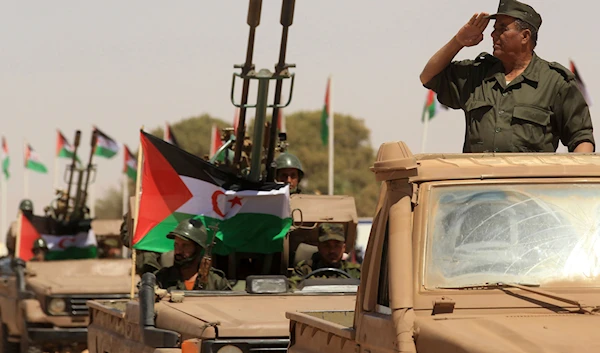 A Polisario Front soldier salutes during a military parade to celebrate the 50th anniversary of the Polisario Front in the Aoussered camp, Algeria, Saturday, May 20, 2023. (AP)