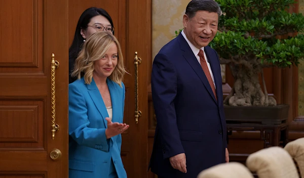 Chinese President Xi Jinping, right, walks with Italian Premier Giorgia Meloni, left, for a meeting at the Diaoyutai State Guesthouse in Beijing, China, on July 29, 2024. (AP)