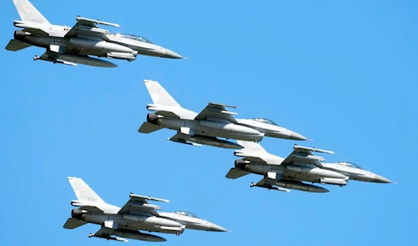 U.S. made F-16 fighter jets fly in the sky over Poland's capital as they take part in a massive military parade to celebrate the Polish Army Day, in Warsaw, Poland, Aug. 15, 2023. (AP)