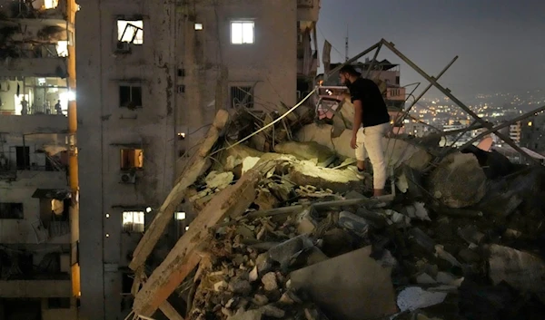 A man inspects a destroyed building that was hit by an Israeli airstrike in the southern suburbs of Beirut, Lebanon, Tuesday, July 30, 2024. (A)