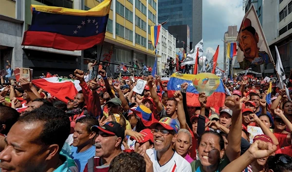 Supporters of Venezuelan President Nicolas Maduro take part in a rally against the secretary general of the Organization of American States (OAS), Luis Almagro, in Caracas on March 28, 2017. (AFP)