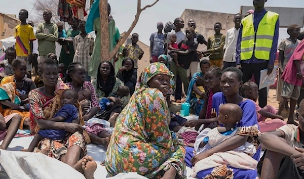 South Sudanese who fled from Sudan sit outside a nutrition clinic at a transit Center in Renk, South Sudan, on May 16,2023.