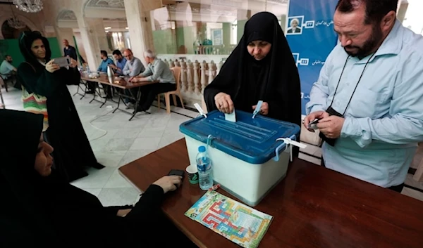 Iranian citizens who live in Syria cast their ballots for the presidential election at a polling station in Syria, Friday June 28,2024. (AP)