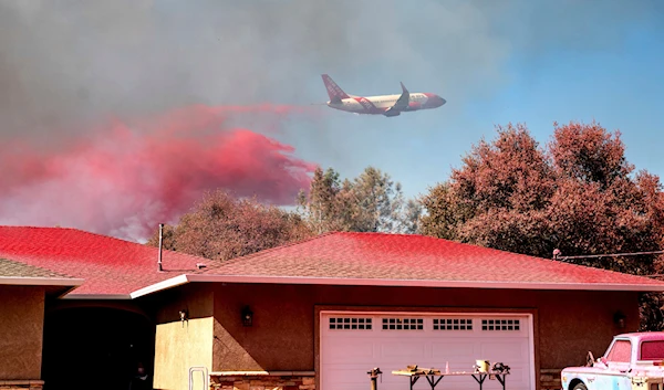 An air tanker drops fire retardant while trying to keep the Grubbs Fire from spreading in the Palermo community of Butte County, Calif., on Wednesday, July 3, 2024. (AP)