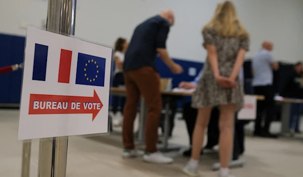 French nationals vote at the Lycée Français de Los Angeles during the first round of French legislative elections, in Los Angeles, on June 29, 2024. (AFP)