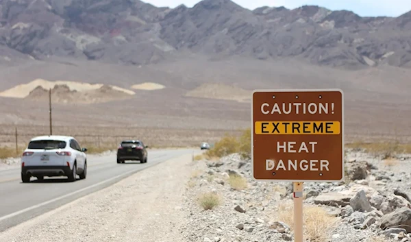 A sign raised across the Southwest, Northeast, and Midwest to caution from extreme heat danger. (AFP VIA GETTY IMAGES)