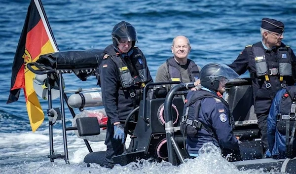 German Chancellor Olaf Scholz, second from left, rides on a boat to the frigate Mecklenburg-Vorpommern on June 5, 2023. (AFP via Getty Images)