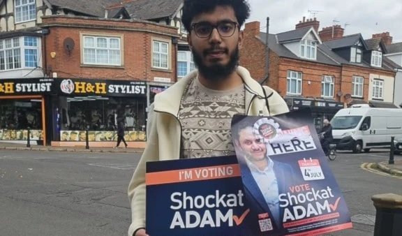 A photo of a voter holding banners to vote for MP Shockat Adam in the UK on July 4, 2024 (X/ShockatAdam)