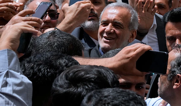 Iranian presidential candidate Masoud Pezeshkian is greeted by his supporters as he arrives to vote at a polling station in Shahr-e-Qods near Tehran, Iran, July 5, 2024. (AP)