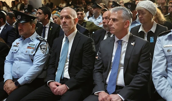 Mossad intelligence agency chief David Barnea, front right, and Ronen Bar, chief of Israel's domestic Shin Bet security agency, attend a ceremony in al-Quds, occupied Palestine, May 13, 2024. (AP)