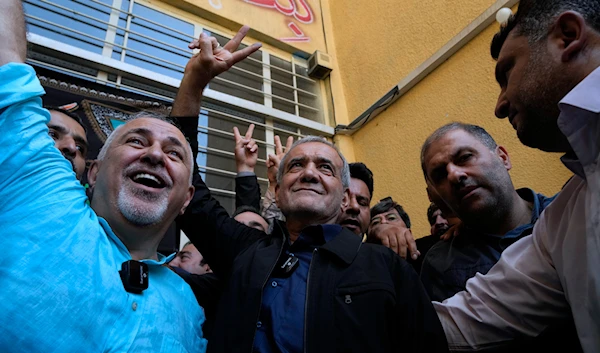 Iran's presidential election winner Masoud Pezeshkian accompanied by former Foreign Minister Mohammad Javad Zarif at a polling station in Shahr-e-Qods near Tehran, Iran, Friday, July 5, 2024. (AP)