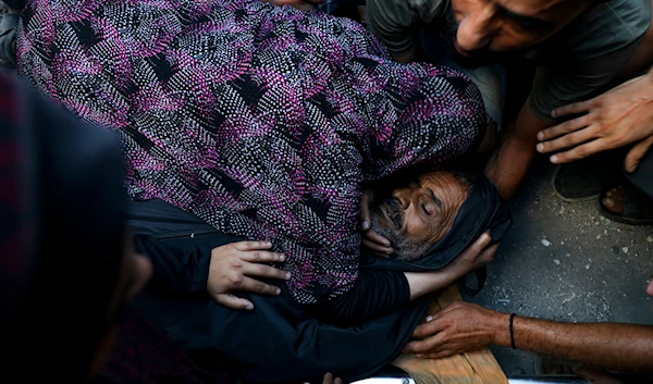 Relatives mourn over the body of a Palestinian man killed in an Israeli airstrike on a U.N.-run school that killed dozens of people in the Nusseirat refugee camp in the Gaza Strip, Saturday, July 6, 2024. (AP)