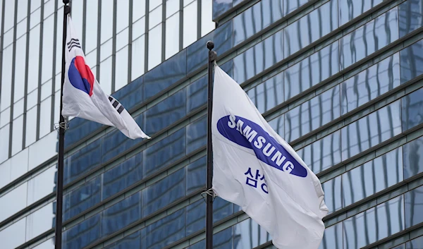 A flag of Samsung, right, and South Korean national flag are seen outside the Samsung Electronics' Seocho building in Seoul, South Korea, on July 5, 2024. (AP)