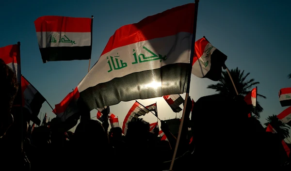 Iraqis chant during a rally before the parliamentary elections in Baghdad, Iraq, October 7, 2021 (AP)