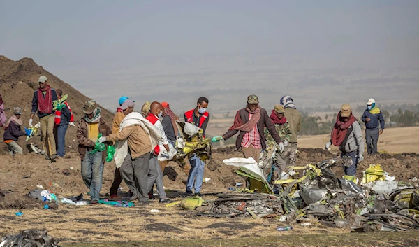 Rescuers work at the scene of an Ethiopian Airlines Boeing Max crash near Bishoftu, or Debre Zeit, south of Addis Ababa, Ethiopia, on March 11, 2019 (AP)