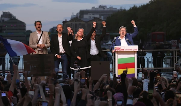 LFI founder Jean-Luc Melenchon, right, clenches his fist with other party members after the second round of the legislative elections Sunday, July 7, 2024, in Paris. (AP)