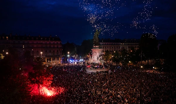 People gather at the Republique plaza after the second round of the legislative election, Sunday, July 7, 2024 in Paris. (AP)