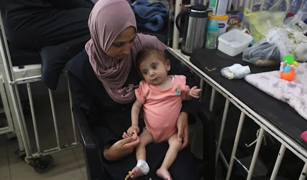 Amira Al-Jojo holds her son Yousef Al-Jojo, 10 months old, who suffers from malnutrition, at Al-Aqsa Martyrs Hospital, where he is undergoing treatment, in Deir al-Balah in the central Gaza Strip on Saturday, June 1, 2024. (AP)