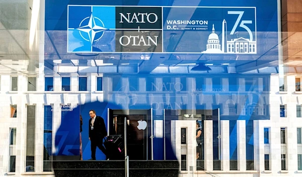 A NATO summit attendee walks through the Walter E. Washington Convention Center in Washington, on Tuesday, July 9, 2024. (AP Photo/Noah Berger)