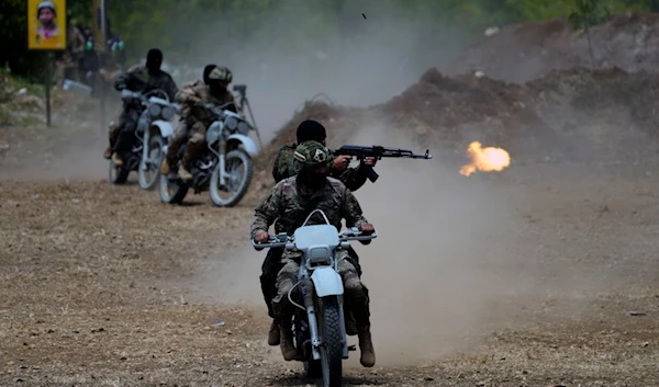 Fighters from the Lebanese Resistance group Hezbollah carry out a training exercise in Aaramta village in the Jezzine District, southern Lebanon, Sunday, May 21, 2023. (AP)