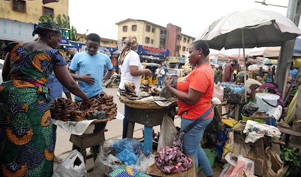 People buy food at a market in Lagos, Nigeria, on Wednesday, July. 31, 2024 (AP(