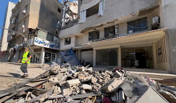 A municipality worker passes by debris of damaged buildings that were hit by an Israeli occupation airstrike on Tuesday evening in the southern suburbs of Beirut, Lebanon, Wednesday, July 31, 2024. (AP)