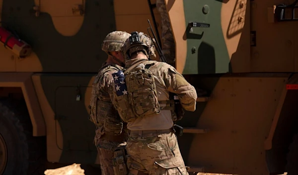 In this Sept. 8, 2019, photo, U.S. soldiers stand near a Turkish armored vehicle on the Syrian side of the border with Turkey near Tal Abyad, Syria. (AP)