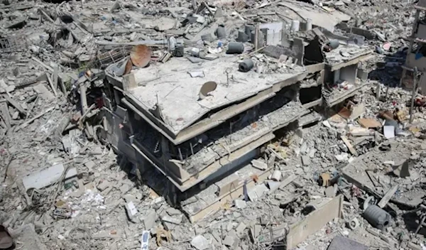 A Palestinian man walks on building rubble in a devastated area around Gaza's Shifa hospital on April 3, 2024 due to deliberate Israeli bombardments (AFP Via Getty Images)