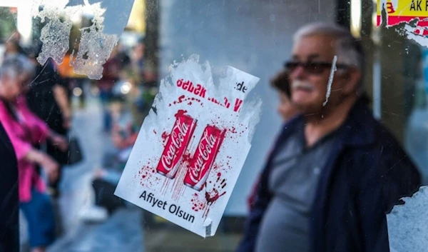 Stickers reading ‘Baby blood in your drink!’ are being used to protest against Coca-Cola, 2023. (AFP)